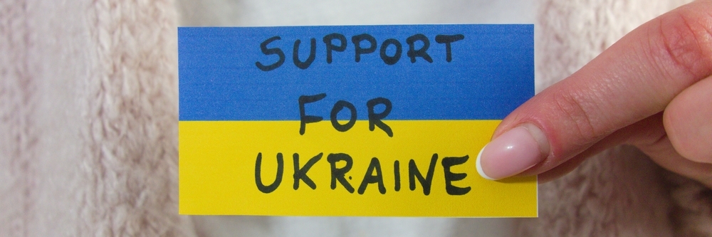 The flag of Ukraine on a paper with words 